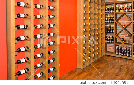 Balaklava, Crimea, Russia-June 2, 2018: Storage of wine bottles on wooden shelves in a wine shop. Collectible wine bottles Balaklava, Crimea, Russia-June 2, 2018: Storage of wine bottles on wooden shelves in a wine shop. Collectible wine bottles 140425991