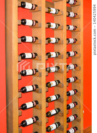 Balaklava, Crimea, Russia-June 2, 2018: Storage of wine bottles on wooden shelves in a wine shop. Collectible wine bottles 140425994