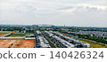 View of a modern housing complex with a stadium in the distance 140426324