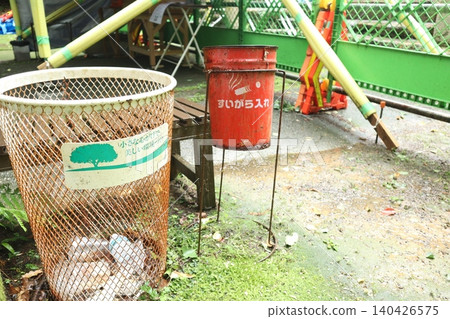 Trash cans and ashtrays in the park 140426575