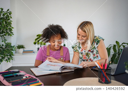 Tutor helping student with homework during private lesson Tutor helping student with homework during private lesson 140426592