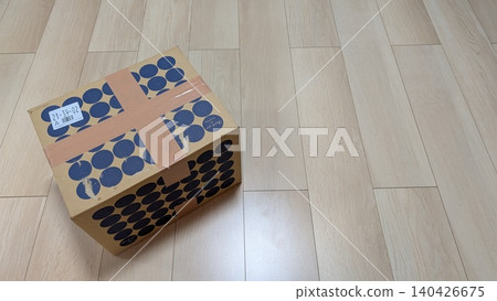 A stylish polka-dot cardboard box #6 placed on a wooden floor. A stylish polka-dot cardboard box #6 placed on a wooden floor. 140426675