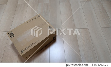 Plain cardboard box #1 placed on a wooden floor 140426677