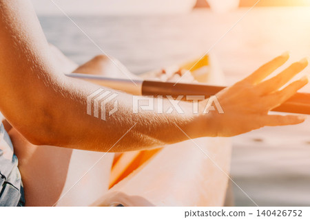 Hand Rowing Kayak Water A close-up of a hand rowing a kayak on the water. Hand Rowing Kayak Water A close-up of a hand rowing a kayak on the water. 140426752