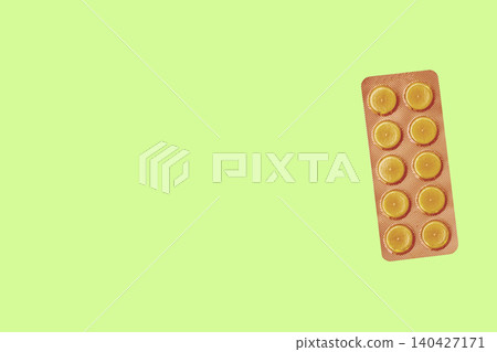 Orange pills in blister pack on light green Orange pills in blister pack on light green 140427171