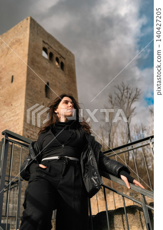 Woman Posing Near Medieval Stone Tower Woman Posing Near Medieval Stone Tower 140427205