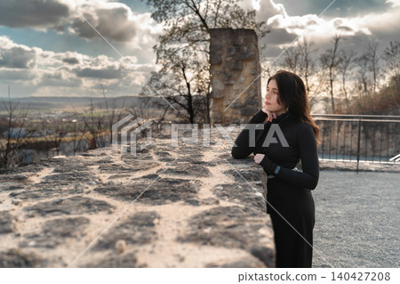 Young Woman at Historic Stone Ruins with Scenic View Young Woman at Historic Stone Ruins with Scenic View 140427208