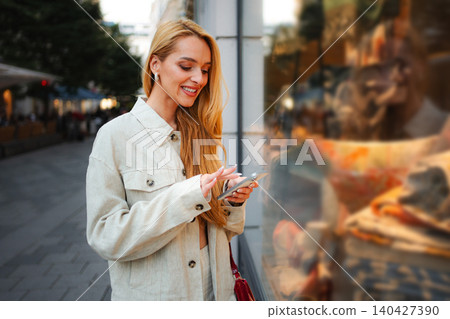 Adult woman scrolling smartphone in city center of Vienna Adult woman scrolling smartphone in city center of Vienna 140427390