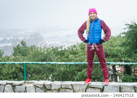 Woman wearing sportswear exercising outside during autumn Woman wearing sportswear exercising outside during autumn 140427518