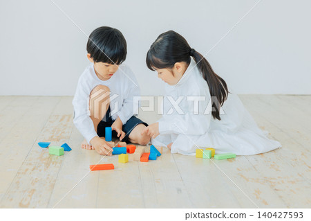Children playing with building blocks Children playing with building blocks 140427593