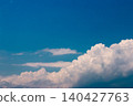 A dramatic summer sky of deep blue and powerful white clouds. 140427763