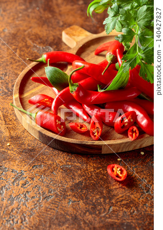 Heap of red hot chili peppers on a kitchen table. Heap of red hot chili peppers on a kitchen table. 140427827