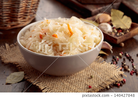 Homemade sauerkraut with carrot on an old wooden table. Homemade sauerkraut with carrot on an old wooden table. 140427848