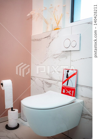 Humorous warning sign on a modern bathroom toilet Humorous warning sign on a modern bathroom toilet 140428211