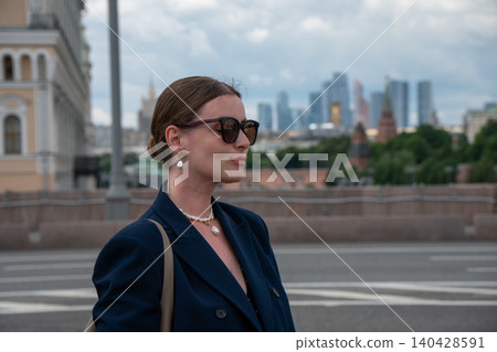 Woman in central Moscow with Moscow City skyscrapers, historic skyline, business district development, cultural heritage in modern capital. City branding, business travel, urban lifestyle, tourism Woman in central Moscow with Moscow City skyscrapers, historic skyline, business district development, cultural heritage in modern capital. City branding, business travel, urban lifestyle, tourism 140428591
