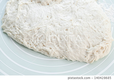 Naan dough that has fermented and contains many air bubbles Naan dough that has fermented and contains many air bubbles 140428685