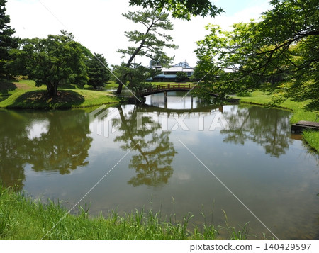 The arched bridge and a single pine tree are clearly reflected in the pond of the scenic former Daijoin Temple Garden. The arched bridge and a single pine tree are clearly reflected in the pond of the scenic former Daijoin Temple Garden. 140429597