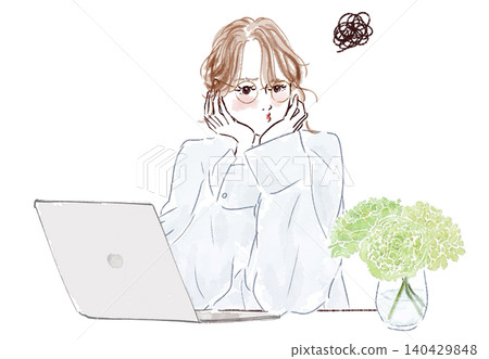 A grumpy woman working on her laptop. 140429848