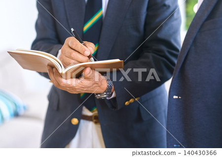 Senior businessmen having a meeting in a conference room Senior businessmen having a meeting in a conference room 140430366
