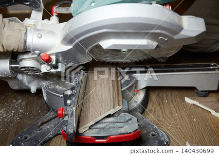 Cutting wood with a power saw in a workshop during the daytime Cutting wood with a power saw in a workshop during the daytime 140430699