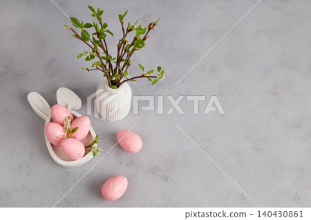 Easter holiday with pastel pink eggs, vase with branches 140430861