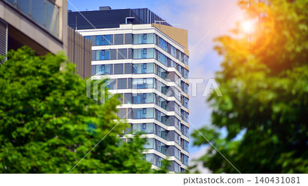 European residential architecture harmonizing with nature. Eco-friendly living in city with greens. Eco apartment building saving energy and fresh air concept. European residential architecture harmonizing with nature. Eco-friendly living in city with greens. Eco apartment building saving energy and fresh air concept. 140431081