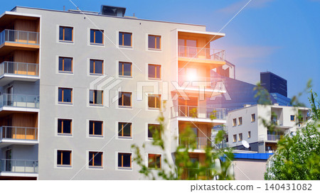 European residential architecture harmonizing with nature. Eco-friendly living in city with greens. Eco apartment building saving energy and fresh air concept.  140431082
