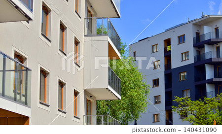 European residential architecture harmonizing with nature. Eco-friendly living in city with greens. Eco apartment building saving energy and fresh air concept.  140431090
