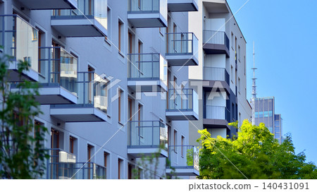 European residential architecture harmonizing with nature. Eco-friendly living in city with greens. Eco apartment building saving energy and fresh air concept. European residential architecture harmonizing with nature. Eco-friendly living in city with greens. Eco apartment building saving energy and fresh air concept. 140431091