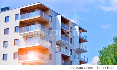 European residential architecture harmonizing with nature. Eco-friendly living in city with greens. Eco apartment building saving energy and fresh air concept.  140431092