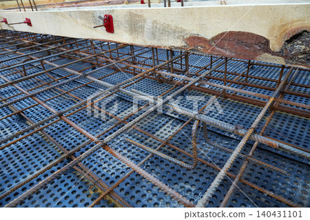 The construction of a concrete foundation using reinforcing steel prepared at the construction site The construction of a concrete foundation using reinforcing steel prepared at the construction site 140431101