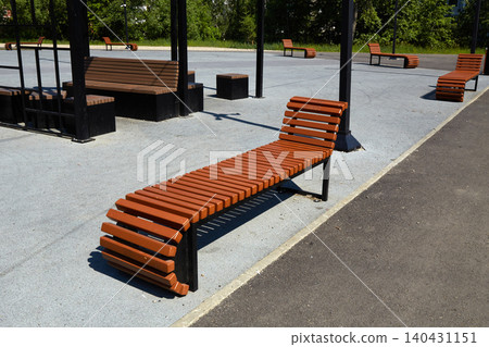 Wooden seating area in outdoor park during sunny day with no people around Wooden seating area in outdoor park during sunny day with no people around 140431151