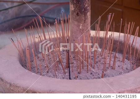 Burning incense in a pot in the temple. Burning incense in a pot in the temple. 140431195