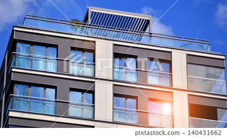 View of modern residential building with glass balconies and bright facade. Contemporary apartment building in european city. Concept of urban living and modern architecture. View of modern residential building with glass balconies and bright facade. Contemporary apartment building in european city. Concept of urban living and modern architecture. 140431662
