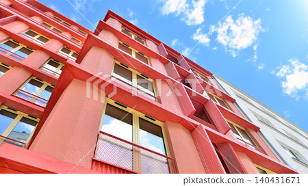 View of modern residential building with glass balconies and bright facade. Contemporary apartment building in european city. Concept of urban living and modern architecture. View of modern residential building with glass balconies and bright facade. Contemporary apartment building in european city. Concept of urban living and modern architecture. 140431671