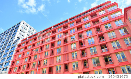 View of modern residential building with glass balconies and bright facade. Contemporary apartment building in european city. Concept of urban living and modern architecture. View of modern residential building with glass balconies and bright facade. Contemporary apartment building in european city. Concept of urban living and modern architecture. 140431673