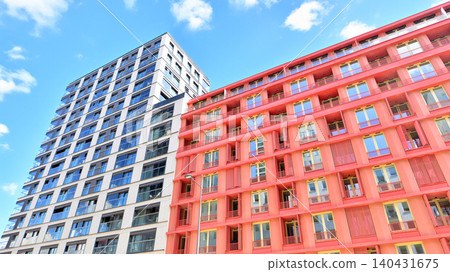 View of modern residential building with glass balconies and bright facade. Contemporary apartment building in european city. Concept of urban living and modern architecture. View of modern residential building with glass balconies and bright facade. Contemporary apartment building in european city. Concept of urban living and modern architecture. 140431675