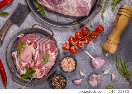 Raw meat steaks preparing with fresh spices and vegetables Raw meat steaks preparing with fresh spices and vegetables 140431880