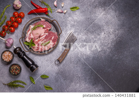 Raw pork steak, chili, garlic, spices, cleaver, and herbs preparing Raw pork steak, chili, garlic, spices, cleaver, and herbs preparing 140431881