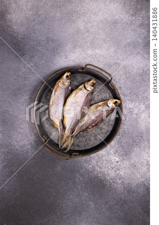 Dried fish snack vobla or taranka on a metal tray Dried fish snack vobla or taranka on a metal tray 140431886