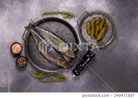 Pickled herring fillets with gherkins, seasoning and rosemary Pickled herring fillets with gherkins, seasoning and rosemary 140431887