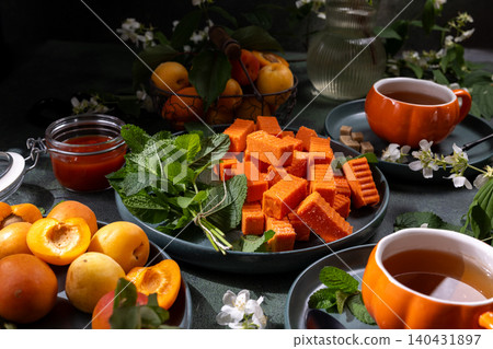 Apricot fruit candy marmalade with mint and hot tea 140431897