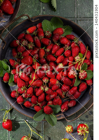 Freshly picked red strawberries filling metal tray Freshly picked red strawberries filling metal tray 140431904