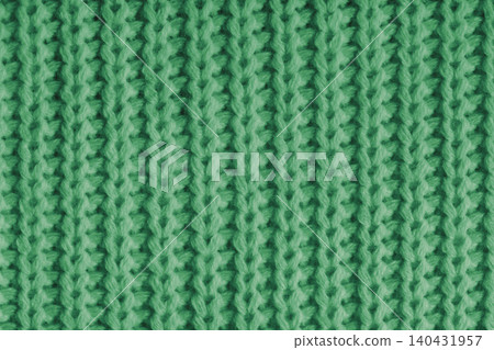 Close up, macro of green knitted fabric texture with yarn stitches, cloth wool background Close up, macro of green knitted fabric texture with yarn stitches, cloth wool background 140431957