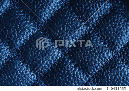 Macro of blue quilted leather texture background with stitched pattern and shining metal effect 140431965