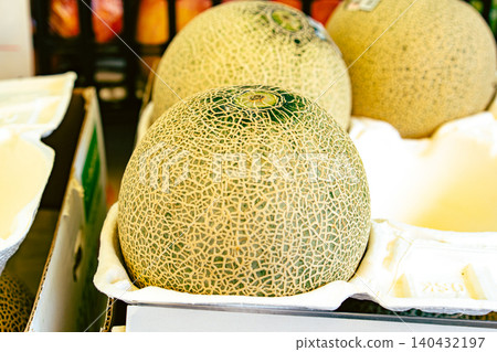 A close-up of a fresh muskmelon with beautiful netting, found in a supermarket or market. A close-up of a fresh muskmelon with beautiful netting, found in a supermarket or market. 140432197