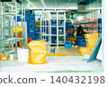 A scene inside a store (or warehouse) where preparations for opening and stocking/displaying merchandise are underway. 140432198