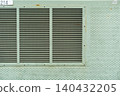 Light green metal vents (louvers) and a dotted industrial texture background. 140432205