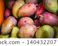 A close-up of a box overflowing with fresh mangoes (apple mangoes). 140432207