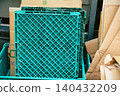 Blue-green folding containers (Oricon) and bundled cardboard boxes placed in the back room 140432209